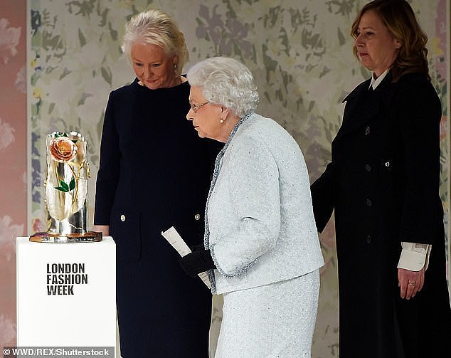 The Queen is pictured with Angela Kelly (left) during London Fashion Week on February 20, 2018