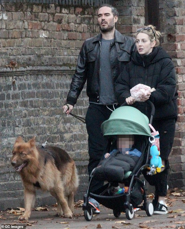 Brand's wife Laura Gallacher, seen on a walk in London in 2017, is a 