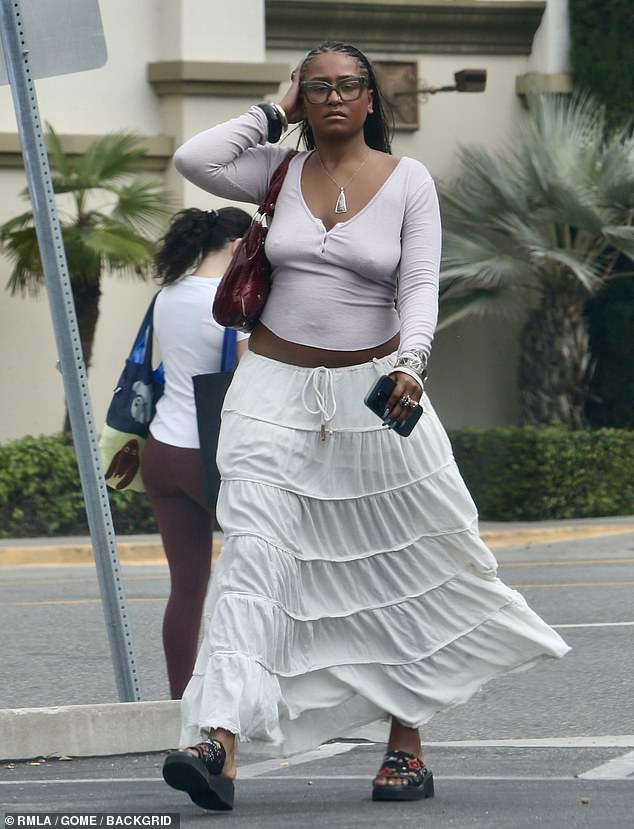 She showed off her figure in a tight long-sleeved shirt as she strolled through a Whole Foods grocery store in LA