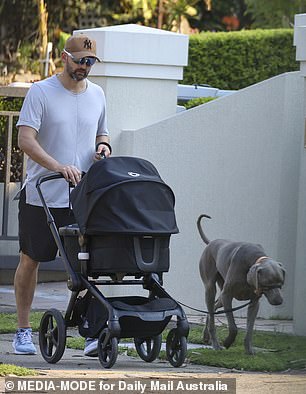 Nathan Lyon walks with a stroller