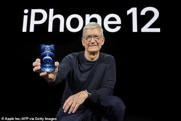 Apple says it will update the software on its iPhone 12 in France to fix the problem.  The device is shown here in the hands of Apple CEO Tim Cook.  Experts say that although the radiation exceeds French standards, it is not high enough to endanger people