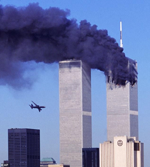 Bill Ellmore has revealed that he subsequently fired the colleague who advised him against one of the September 11 hijacked flights.  Pictured: American Airlines Flight 175 flies toward the South Tower of the World Trade Center while the North Tower is on fire