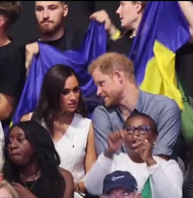 Prince Harry and Meghan were seen in an animated conversation yesterday while watching a volleyball match between Ukraine and Nigeria at the Invictus Games