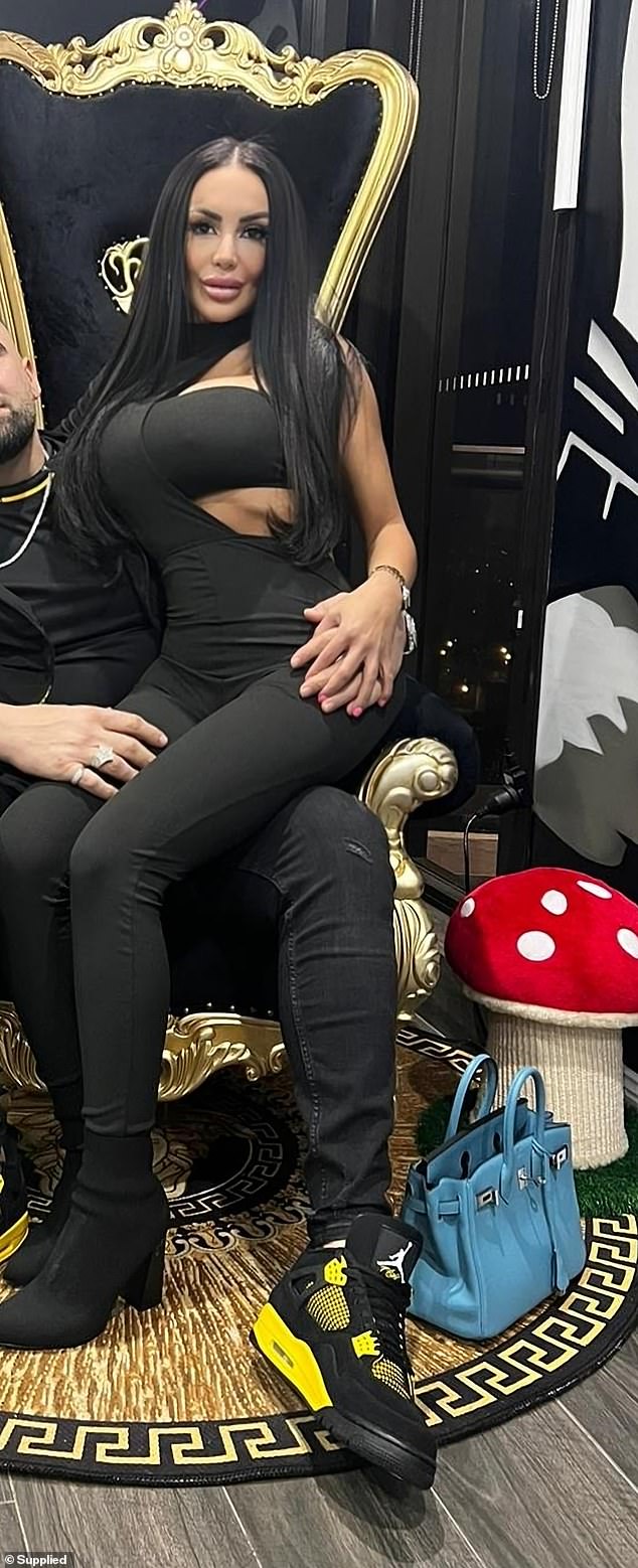 Sydney hairdresser Fatima Hage, 30, sits on her new husband Mahmoud 'Bargo' Bargshoon's lap, reportedly wearing a watch that has sparked a bitter six-month feud