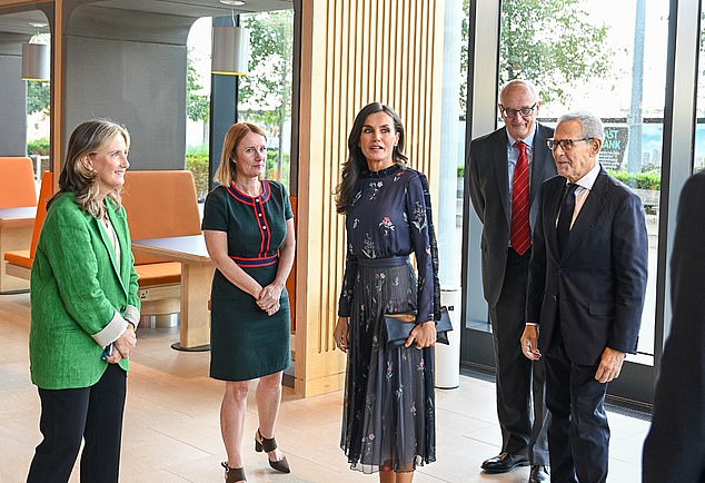 Queen Letizia of Spain dazzled onlookers in a pleated dress by Giorgio Armani during a visit to Cancer Research UK's headquarters in Stratford, London