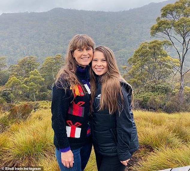 Terri is seen wearing a sweater decorated with presents as she poses next to her daughter Bindi