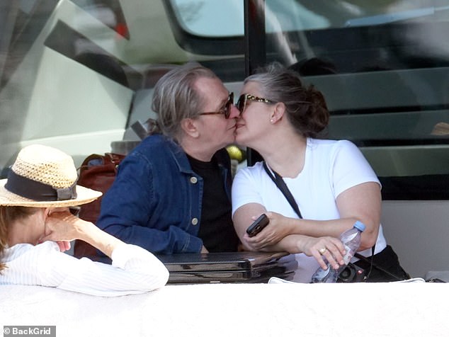 In love!  Gary Oldman and his wife Gisele Schmidt looked as in love as ever as they set up a display full of PDAs while vacationing in Capri, Italy, on Saturday