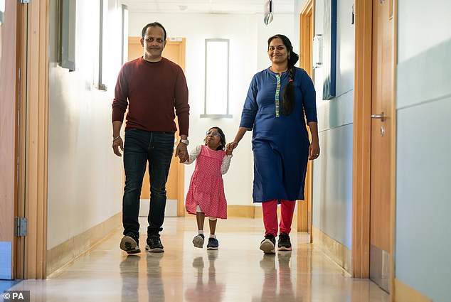 Aditi, 8, pictured with father Uday and mother Divya at Great Ormond Street Hospital, London, a year after a life-changing kidney transplant