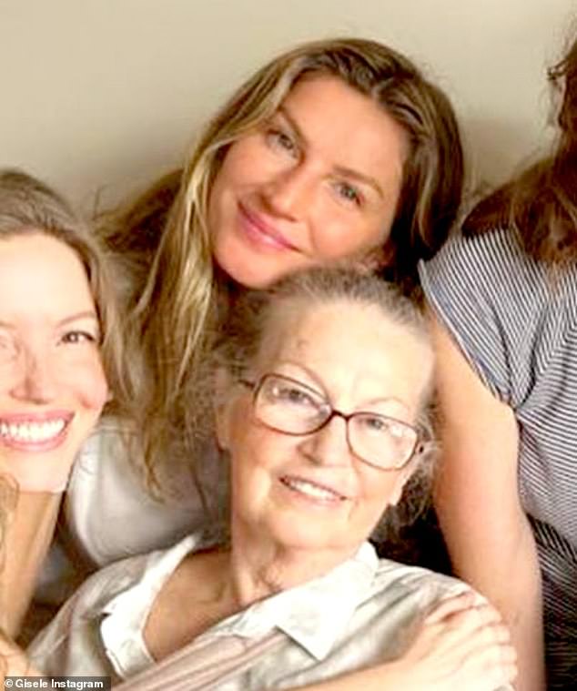 Close family ties: Gisele sat in the back row, her mother in the front