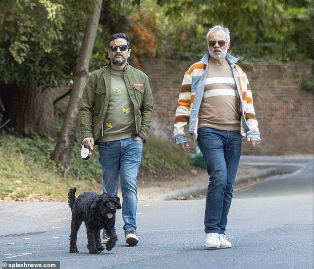 Walking: Graham Norton was spotted on Sunday taking a relaxing dog walk with his husband Jonathan McLeod through Hampstead in North London