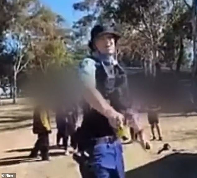 Footage has emerged of a police officer threatening a man with a Taser after a boy was allegedly tackled off his motorbike in a quiet suburban park