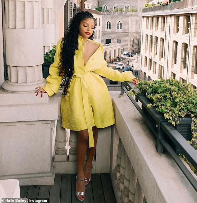 Golden hour: Halle Bailey was the epitome of elegance on Saturday, dressed from head to toe in Dolce & Gabbana, including a low-cut yellow jacket dress, a diamond necklace, matching earrings and silver heels