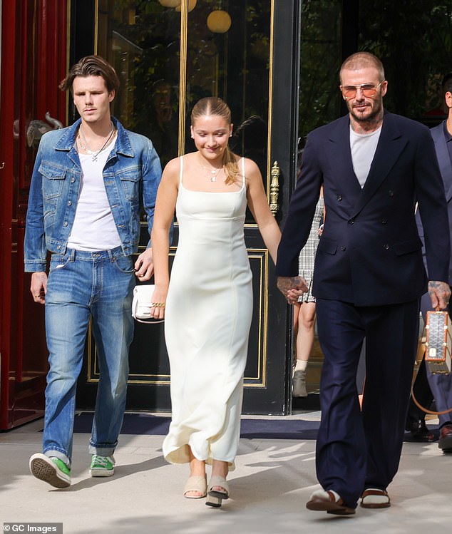 Three's company: The Beckham clan was out in force as they went to support Victoria Beckham at her Paris Fashion Week show on Friday (LR Cruz, Harper and David)