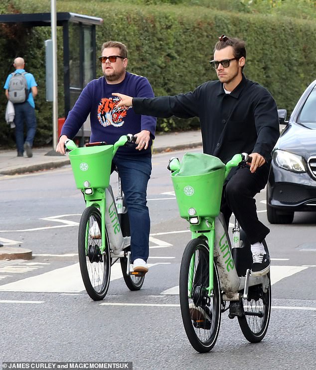 Make way: London shoppers got an unexpected treat on Wednesday after spotting Harry Styles and James Corden as they cycled around the city