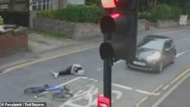 The rider lay motionless for a moment before rolling onto his side as drivers rushed to his aid