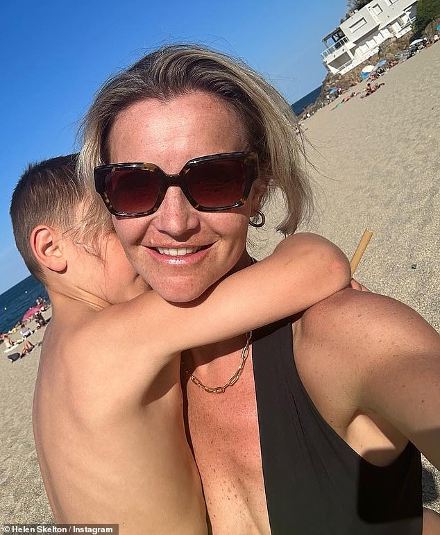 Love: Helen shared a hug on the beach with one of her sons