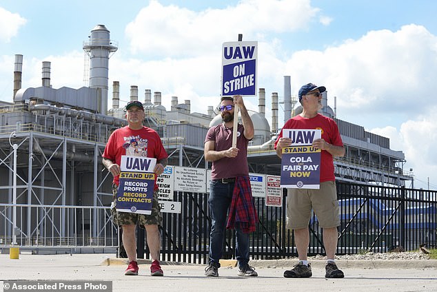 Members of the United Auto Workers walk along a picket line during a strike Friday at the Ford Motor Company Michigan Assembly Plant in Wayne, Michigan