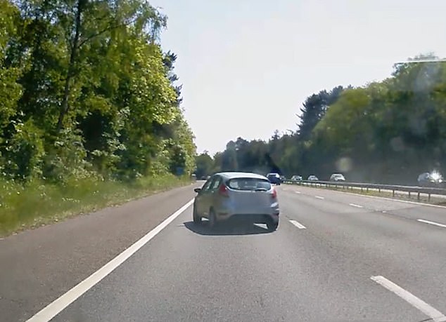 Dashcam footage has captured the horrifying moment when a car snakes across three lanes of a highway, drives up a grassy embankment before flipping over and landing on its roof