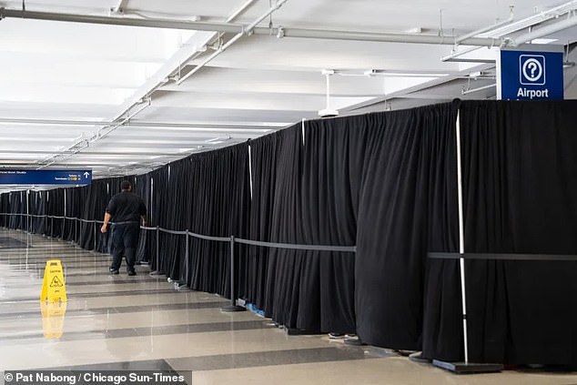 Hundreds of migrants are being hidden behind this black curtain at Chicago's O'Hare airport, where asylum seekers have reported inhumane living conditions, with families forced to sleep on the floor for up to 10 days.