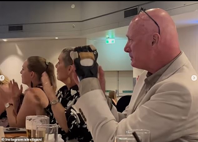 Graham 'Banger' McBride applauds with a heavily tied hand as his daughter Kyah McBride is named among three Singleton Roosters players, all crash victims, as nominees for an award