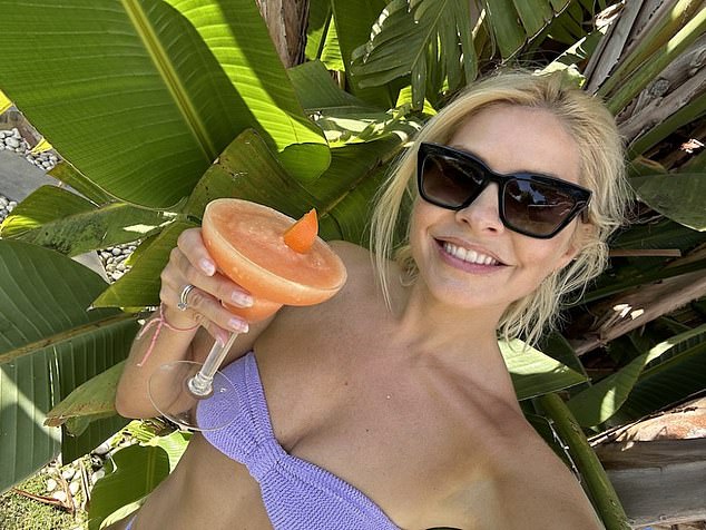 Looking good: Holly shared several snaps of herself soaking up the sun in a bikini, shielding her eyes behind a pair of sunglasses