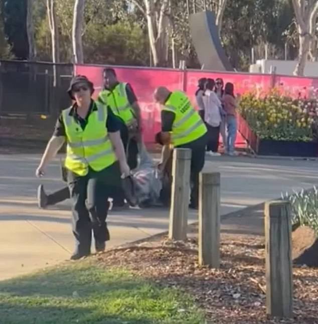 There were shocking scenes at the Floriade festival in Canberra on Sunday when a man was dragged away from the event by several security guards (pictured)