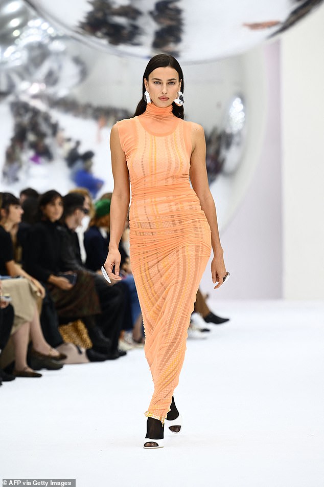 All eyes on her: Irina Shayk, 37, exuded elegance in a semi-sheer tangerine dress for the Missoni show during Milan Fashion Week on Saturday