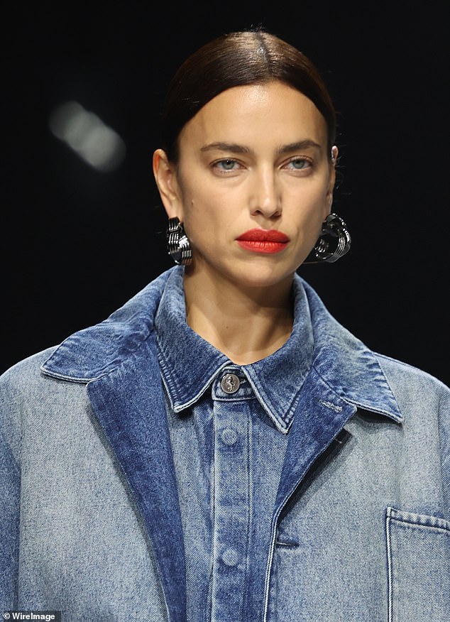 Gorgeous: the Russian beauty wore statement earrings and bold red lipstick