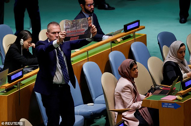 Gilad Erdan, Israel's ambassador to the United Nations, is seen protesting as Iran's president speaks on Tuesday.