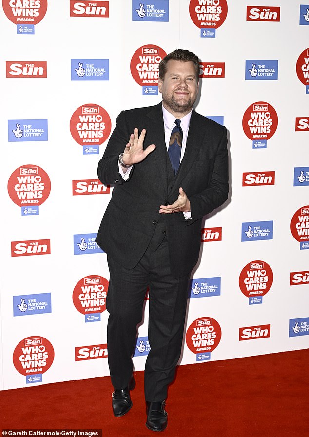 All smiles: The former chat show host, 45, dressed to impress in a smart black three-piece suit which he teamed with a crisp white shirt and blue satin tie.