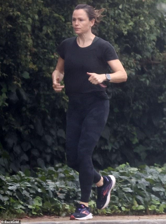 Rain or shine: Jennifer Garner didn't let the rain stop her from doing her daily cardio on Saturday