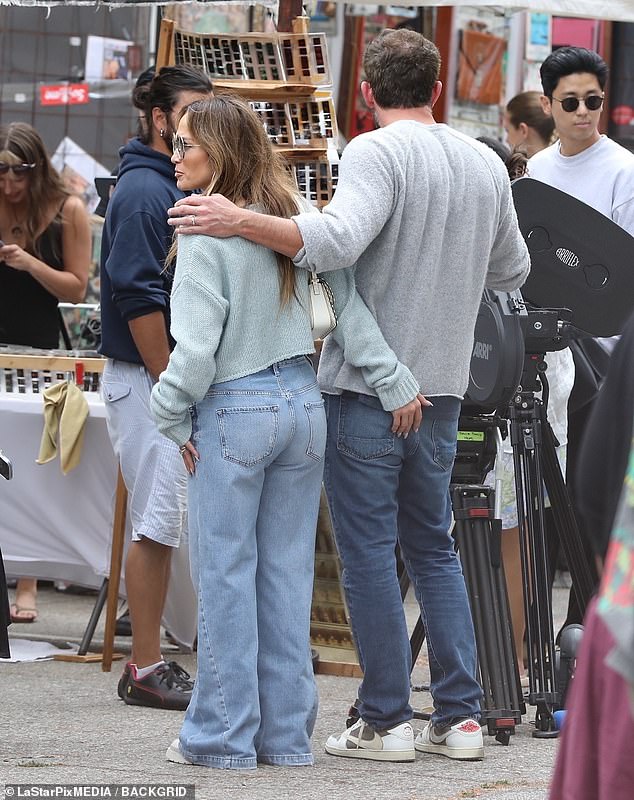 Getting handsy: The loved-up couple strolled with their arms around each other - with JLo even flirtatiously placing a hand on her husband's derriere at one point