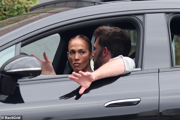 Serious conversation: Jennifer Lopez looked tense as she sat in the passenger seat next to her husband Ben Affleck as they took a drive together through Los Angeles, California