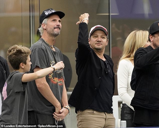 Day out: Jeremy Renner was in good spirits as he cheered on the field at an NFL game in Los Angeles on Sunday, nine months after nearly losing his life in a horrific snowplow accident