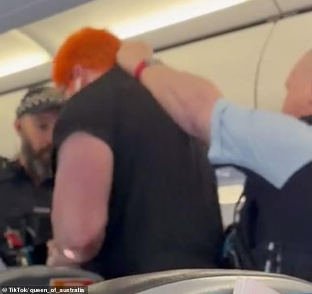 Dramatic footage has captured the moment a Jetstar passenger was dragged off a plane by police after being accused of verbally abusing other travelers