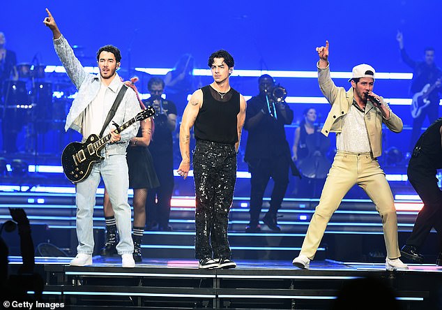 Back on stage: Joe Jonas, 34, joined his brothers, Kevin and Nick, on stage in Las Vegas on Friday during their Five Albums, One Night tour amid his shocking divorce from Sophie Turner