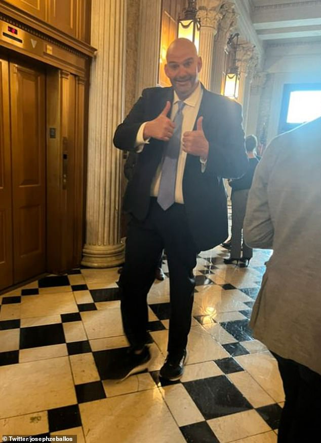 Fetterman beamed as he walked in on the president in the Senate chamber on Thursday, giving his new outfit two thumbs up as he entered