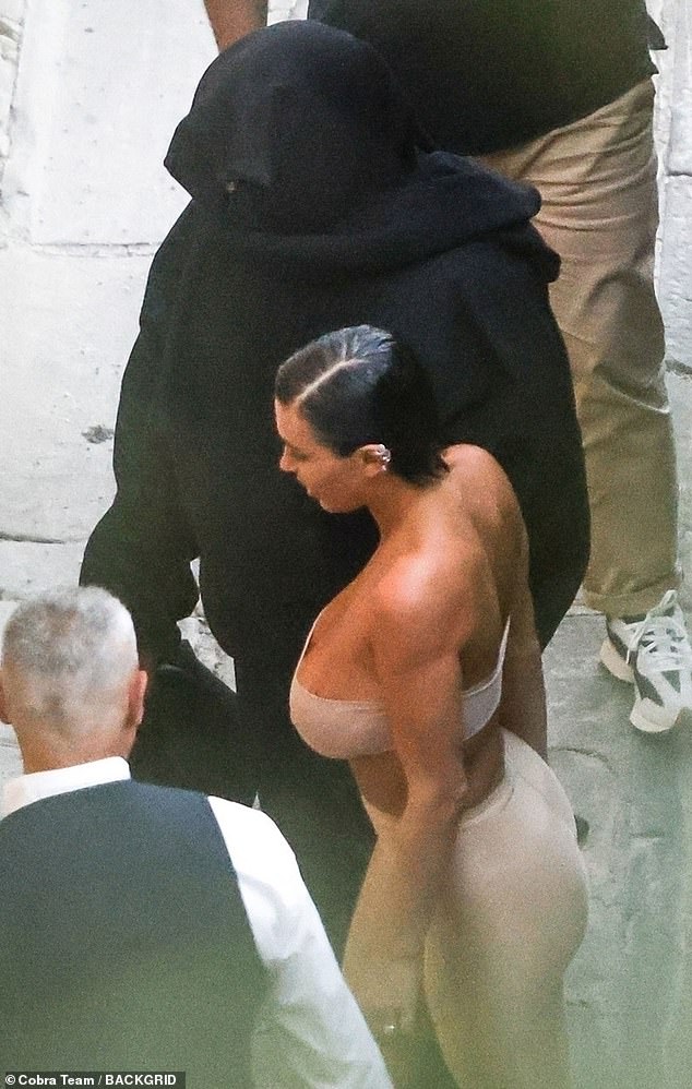 Opposites: Kanye West's 'wife' Bianca Censori turned heads again on Monday with a revealing look while dressed in black clothing