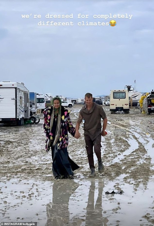 In one photo, Kelly and Joel are seen holding hands as they wade through the muddy Nevada desert
