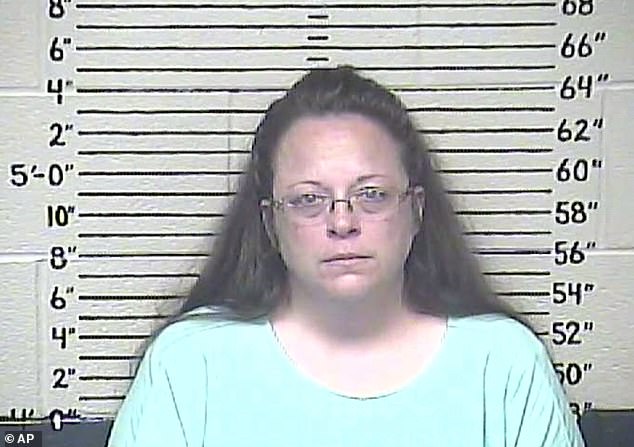 Kim Davis (pictured in mugshot) ordered to pay $100,000 to a gay couple after refusing to grant them a marriage license in 2015