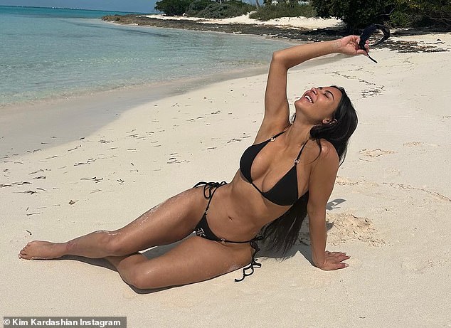 Stunning: Kim Kardashian set pulses racing on Tuesday as she posed up a storm in a skimpy black bikini for sizzling Instagram photos