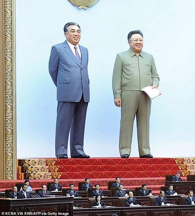 In a not-so-subtle tribute to his ancestors, Kim appeared at the People's Assembly on Thursday, sitting behind a huge wooden desk, while the two 75-foot-tall models loomed large behind him on a stage, smiling over the crowd of party members.