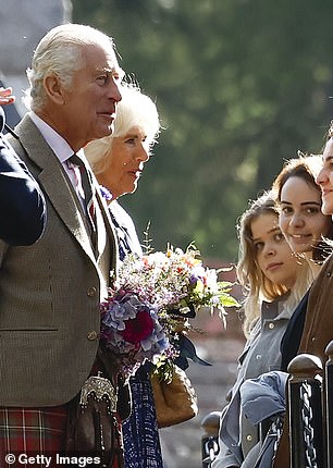 King Charles speaks to people at Crathie Kirk near Balmoral and collects bouquets and cards from schoolchildren