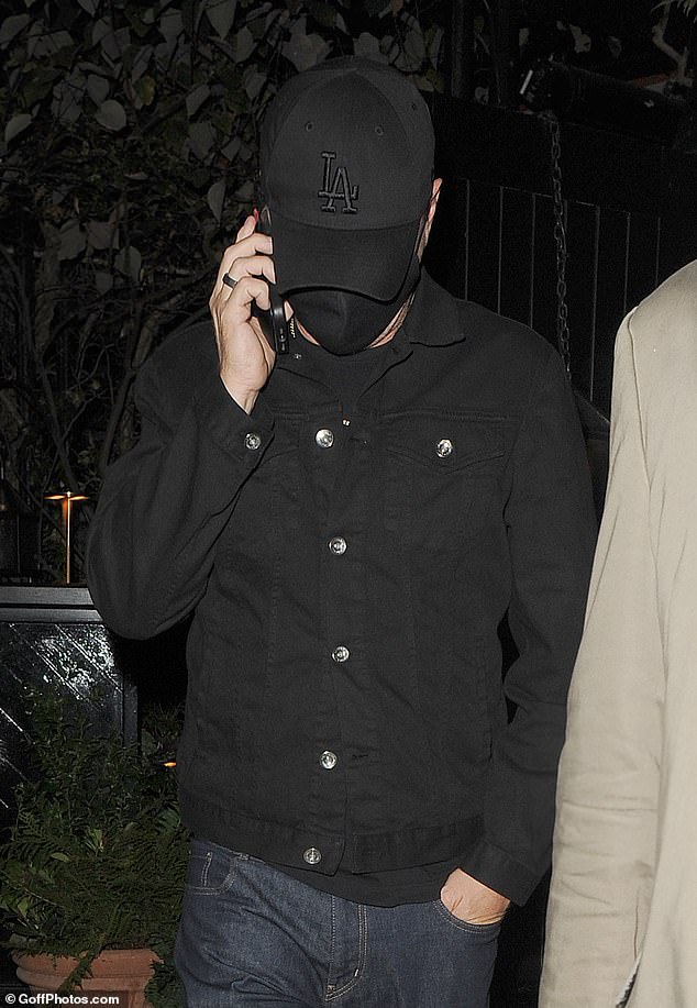 Low key: The Hollywood heavyweight wore his signature black cap and face mask combo during the restaurant outing