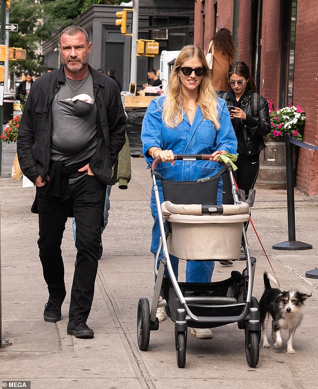 Outing: The actor, 55, who welcomed his first child with Taylor, 31, on August 27, carried adorable Hazel in a gray sling while his new wife walked alongside him with a stroller