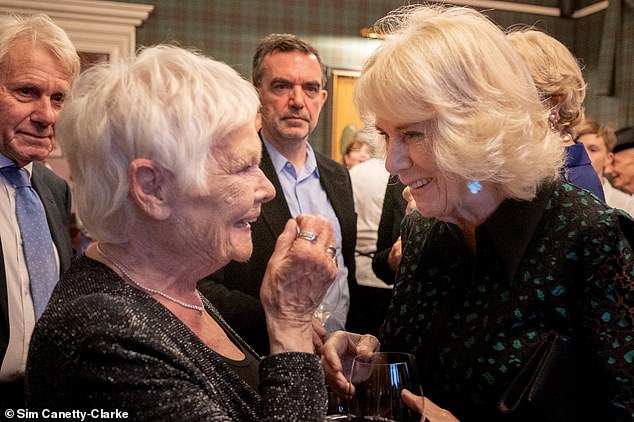 Queen Camilla (pictured with Dame Judi Dench) showed off her fashion chops in a striking leopard print dress as she attended the Braemar Literary Festival last night