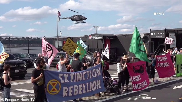 The eco-warriors also held strollers and children's toys as they stood on the picket line - which members of Extinction Rebellion said 'symbolized what is at stake, the livelihoods of our children and our families'