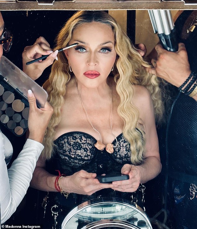 Lacy and sassy: Madonna was seen almost out of her black lace corset top in new images shared on Instagram on Tuesday