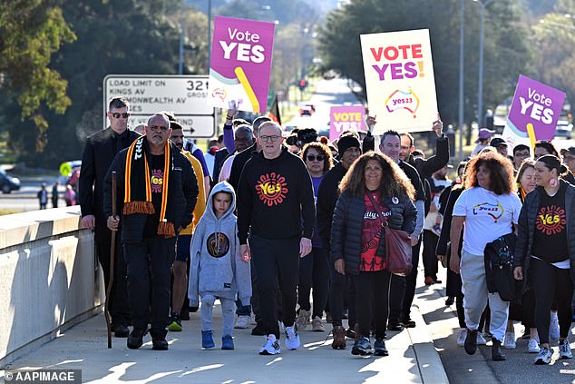 Prime Minister Anthony Albanese and former AFL player Michael Long walk to Parliament House after completing a 20-day walk for the Yes campaign in Canberra