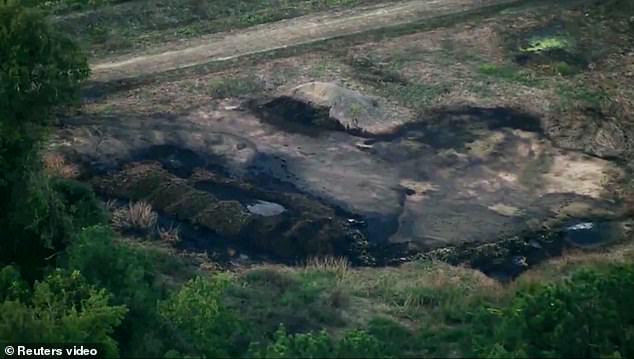 The scorched earth of the crashed fighter jet is visible in South Carolina on Monday